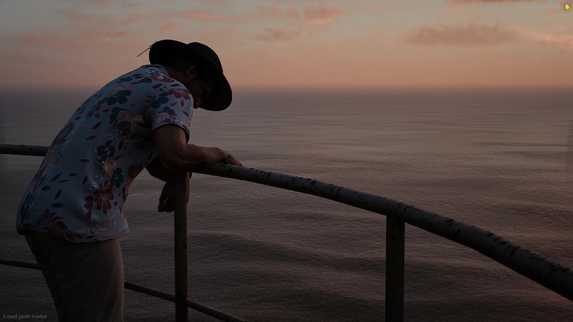 A Circuit resident in a cowboy hat looking over the ocean at sunset